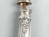 a silver spoon with a silver handle on a table