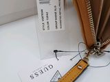 a purse with a tag on it sitting on a table