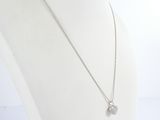 silver plated necklace with a heart shaped pendant on a white mannequin