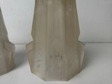 pair of clear glass vases sitting on top of a white table
