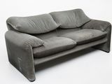 grey couch with pillows on it on a white background