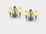 a pair of green sconces mounted on a wall next to a lamp