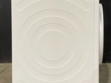 an image of a white washing machine on a tiled floor