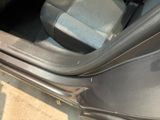 a close up of a car door handle with a seat belt