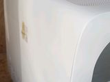 a white toaster sitting on a counter with a sticker on it
