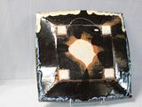 a black and white plate with an orange design on it
