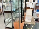 a display case with a glass door in the middle of a room
