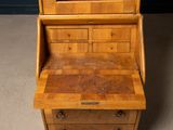 a wooden desk with drawers and a mirror on top of it