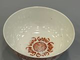 bowl with a red and white design on the outside of it