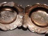 pair of silver plated bowls with handles on a gray surface