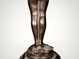 an image of a bronze statue of a woman holding her hands in the air