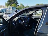 a dog sitting in the driver ' s seat of a car
