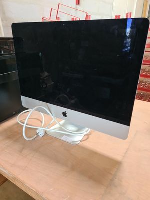 a computer monitor sitting on top of a wooden table