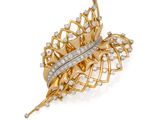 a gold and diamond leaf broochle, by van cleef
