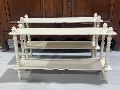 a white shelf with three shelves on top of it