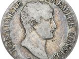 Gros plan sur une pièce de monnaie portant le visage d'un homme