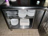 a stainless steel counter with plates on it in a kitchen