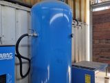 a large blue tank sitting next to a blue machine