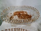 a glass bowl with cinnamon on it sitting on a pillow