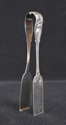 pair of silverware spoons with handles on a black background