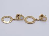 a pair of gold and oplite earrings