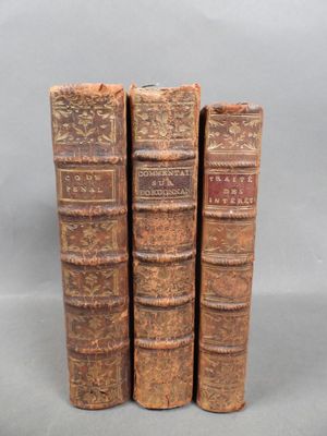 three old books sitting on top of each other on a table