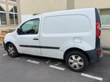 a white van parked in a parking space next to a building