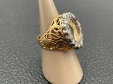 a close up of a gold ring with a diamond on top of it
