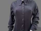 an image of a mannequin wearing a black dress with buttons