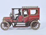 a red toy car with a man sitting in it