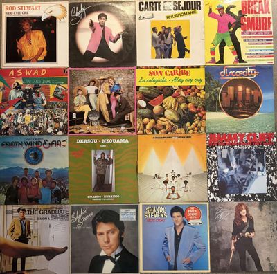 a wall covered with many different album covers on it