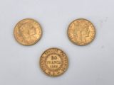 three gold coins, one with the head of a woman and one with a crown