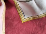 a close up of a pink and white scarf with a picture on it
