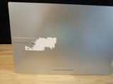 an apple macbook pro laptop with a sticker on the back of it