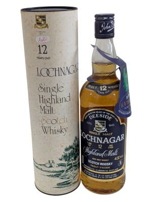 a bottle of scotch whisky next to a cardboard box