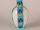 a blue and white vase sitting on a white surface