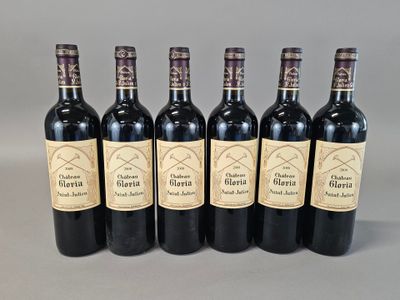 six bottles of wine are lined up in a row on a gray surface