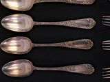a lot of spoons and forks in a black box