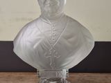 a close up of a glass bust of a man on a table