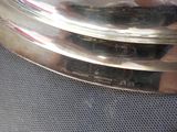 a close up of a silver plate on a table