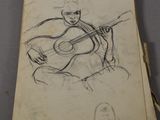 a drawing of a man playing a guitar on a piece of paper