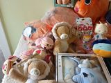 many stuffed animals that are sitting on a bed