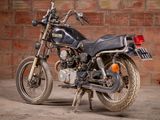 a motorcycle that is parked in front of a brick wall