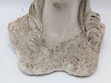 a statue of a woman with long hair on a white surface