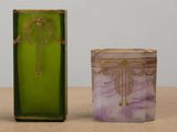 purple and green glass candle holder next to a green glass candle holder