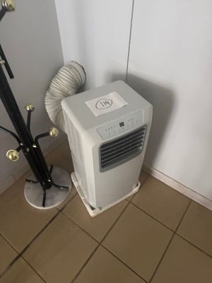 a small air conditioner in the corner of a room