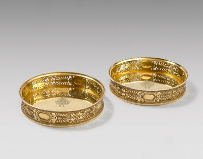 pair of gold plated bowls with floral designs