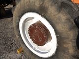 a large tire with a white rim on the ground