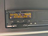 a digital clock on the dashboard of a car