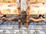two chairs that are sitting next to each other on a rug